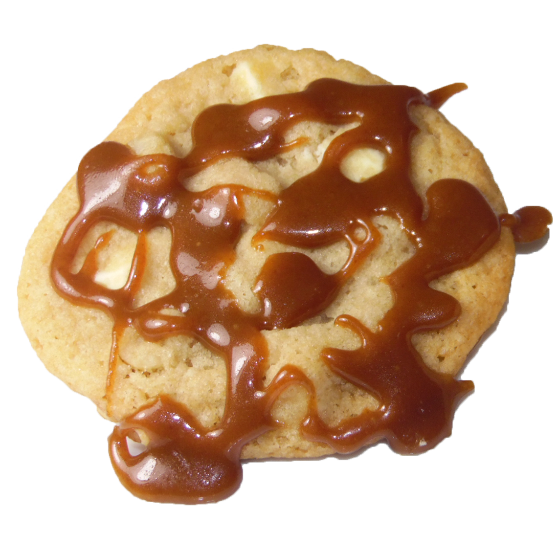 White chocolate chip cookie with macadamia nuts and a caramel drizzle.